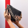 A Stella McCartney Croc-effect embossed Frayme handbag in black ($1,995), available at The Shops at Crystals