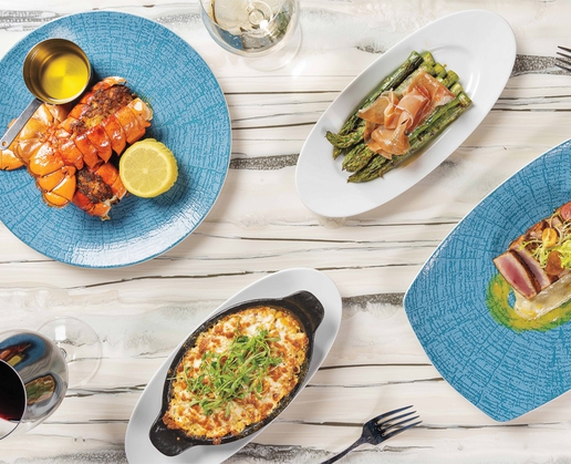 The stuffed lobster tail, asparagus and prosciutto, baked street corn and seared ahi tuna at Top of the World at The STRAT in Las Vegas
