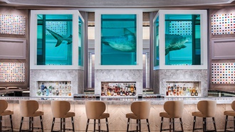 The Palms destination displays a Damien Hirst shark sculpture.