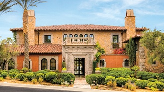 This two-story mansion offers lush landscaping and scenic views of the waters.