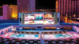 The property’s pool complex Stadium Swim hosts a night of EDM fun.