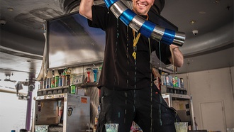 Thbe Carnaval Court flair bartender throws guests a good time.