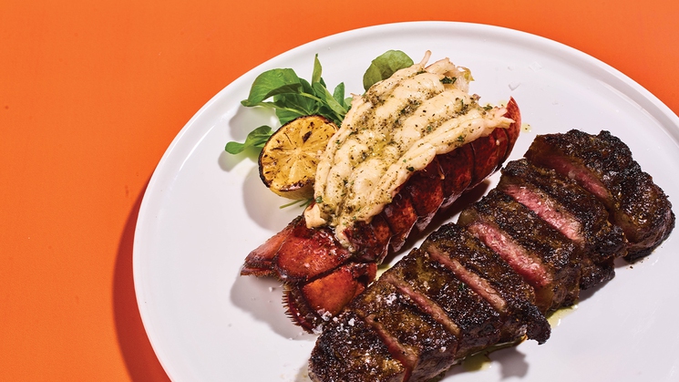 New York strip, accompanied by a lobster tail, at Caramella at Planet Hollywood in Las Vegas