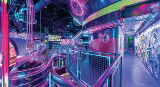 A neon-filled world of art and experience await the curious at Meow Wolf's AREA15 attraction.